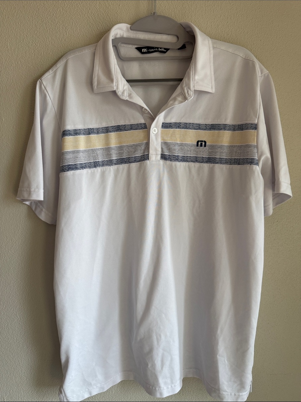 Travis Mathew White Polo with Navy and Cream Chest Stripes
